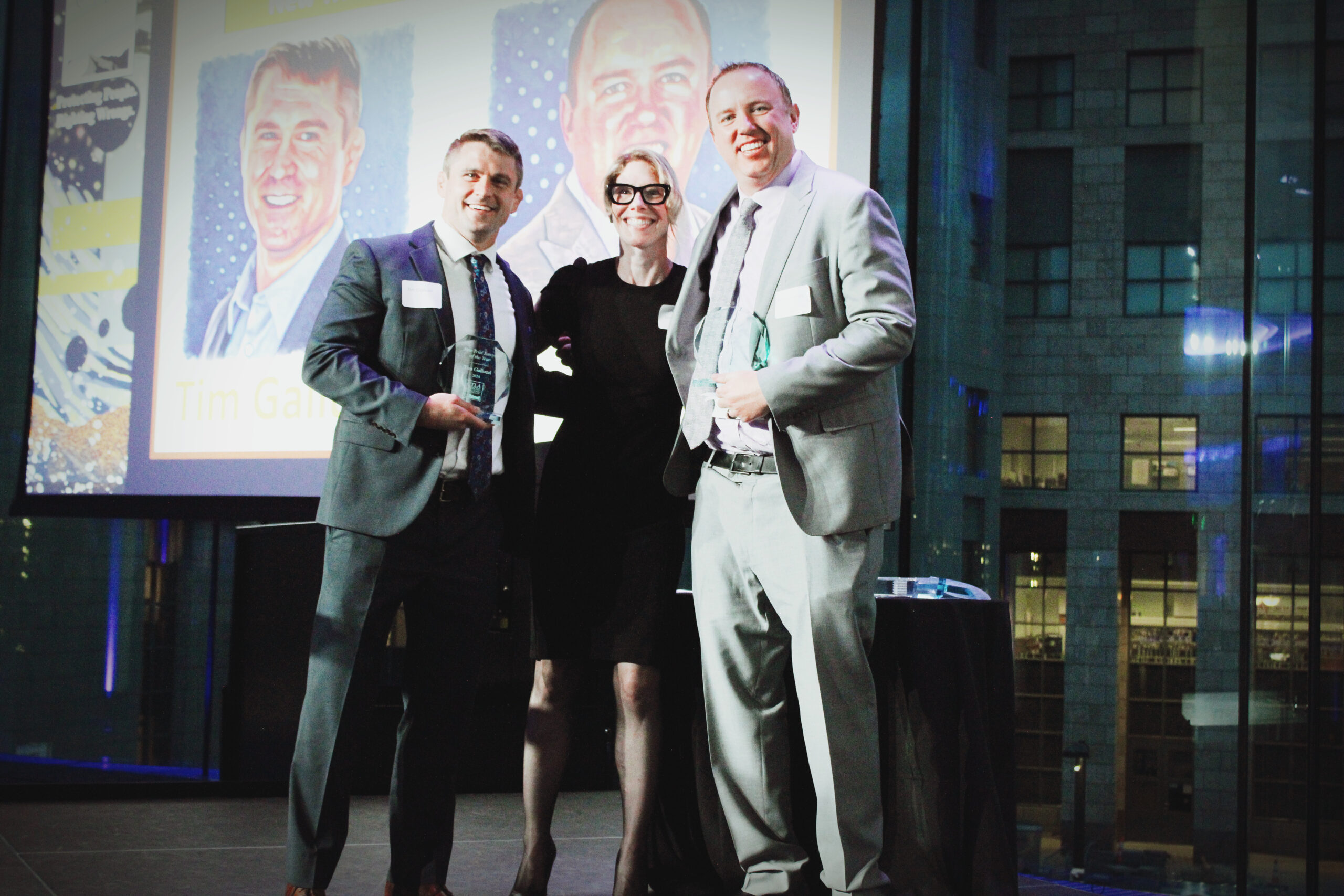 Kevin Cheney and Tim Galuzzi hold their New Trial Lawyer of the Year Awards with CTLA president Kari Jones Dulin