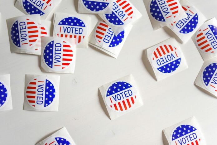 stickers say “I voted” against a white background