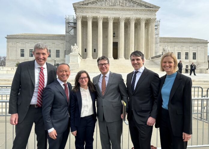 Eric Olson, Kenzo Kawanabe, Abigail Hinchcliff, Sean Grimsley, Jason Murray and Isabel Broer stand in front of the U.S. Supreme Court.