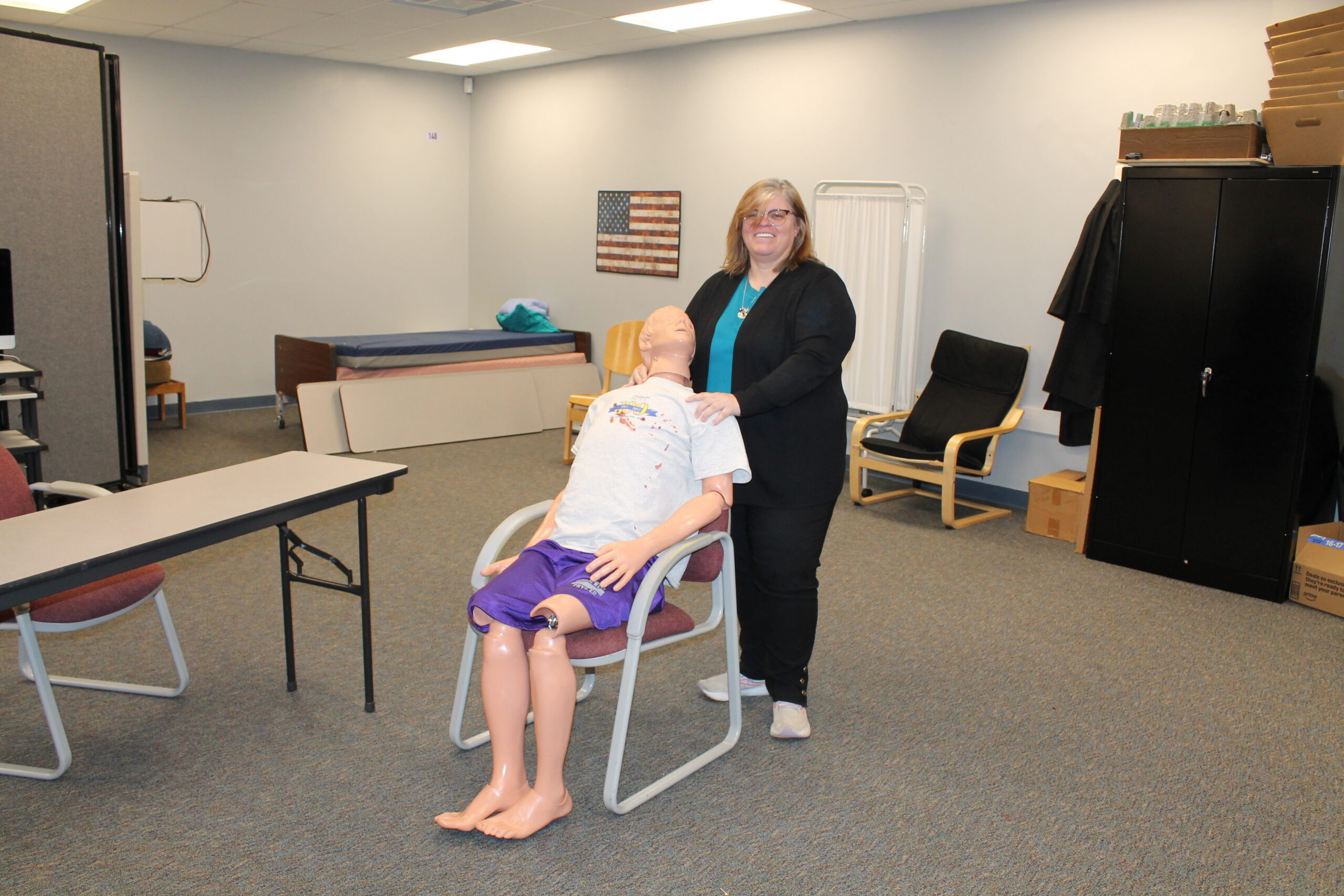 Valarie Purl stands behind a lightly bloodied lab dummy named Bruce in the program’s lab room just outside of the classroom at Warren Tech North. 