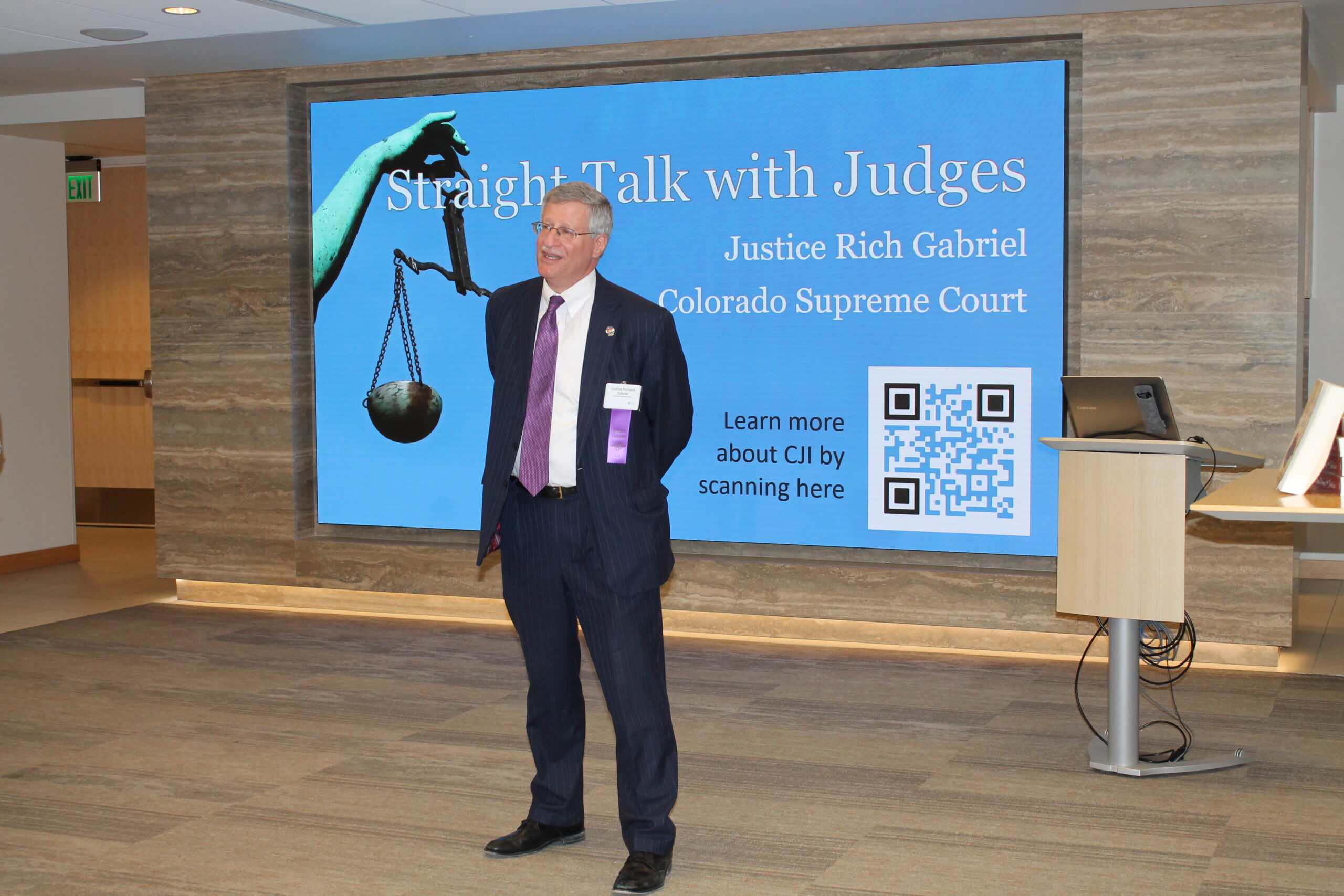 Colorado Supreme Court Justice Richard Gabriel addresses the networking room at the beginning of “Straight Talk with Judges”